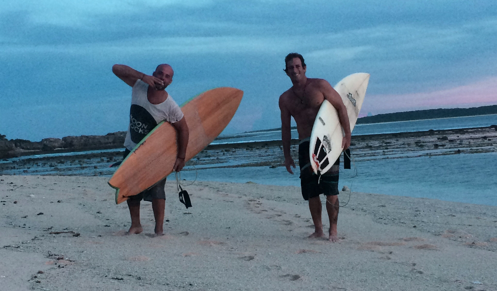 Chef Jose at the beach in front hotel 81 palms and next door in rote island and friend with surfboards ready to surf