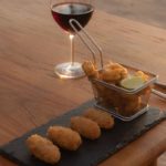 delicious croquettes with a glass of red wine