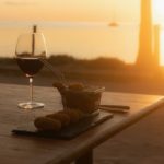 delicious croquettes with a glass of wine on a table with sunset view at hotel 81 palms in Rote island